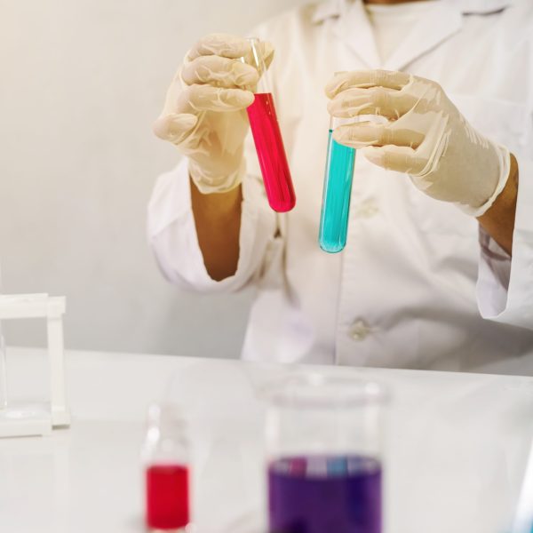 Scientist with equipment working at laboratory with test tubes